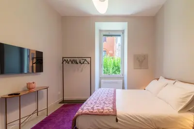 a small bedroom with a bed and a window at Casa Barbieri boutique apartment Flaminio in Rome