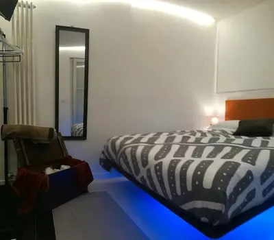 a bedroom with a black and white bed and a mirror at Little gem in Trevi Fountain in Rome