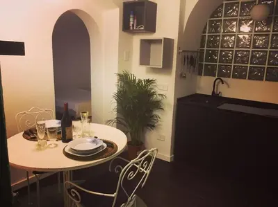 a table and chairs in a kitchen with a sink at Little gem in Trevi Fountain in Rome