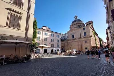 a group of people walking down a street with buildings at Monti in Rome
