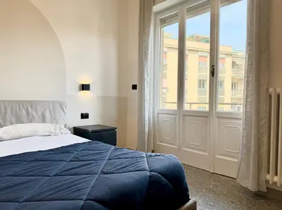 a bedroom with a bed and a large window at Casa Fernanda in Rome