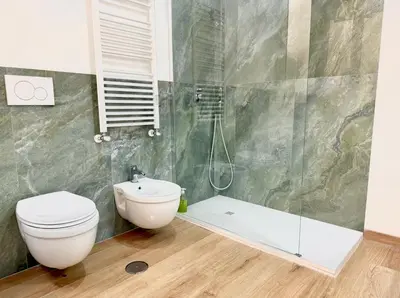 a bathroom with a toilet and a shower and a sink at Casa Fernanda in Rome