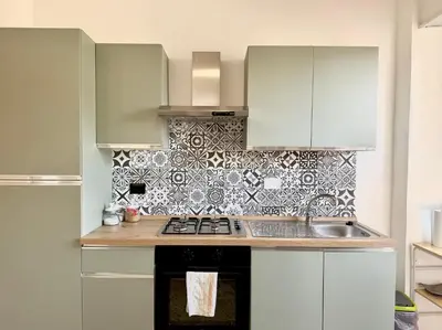 a kitchen with a sink and a stove top oven at Casa Fernanda in Rome