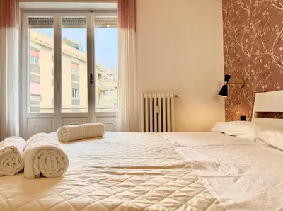 a bedroom with a large bed with towels on it at Casa Fernanda in Rome