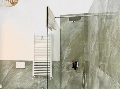 a shower with a glass door in a bathroom at Casa Fernanda in Rome