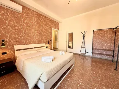 a bedroom with a bed with towels on it at Casa Fernanda in Rome