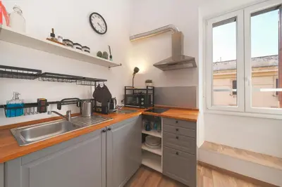 a kitchen with a sink and a window at Elena's Apartment - Piramide Metro Station in Rome