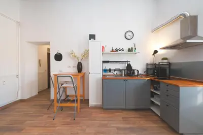a kitchen with a counter and a table in it at Elena's Apartment - Piramide Metro Station in Rome