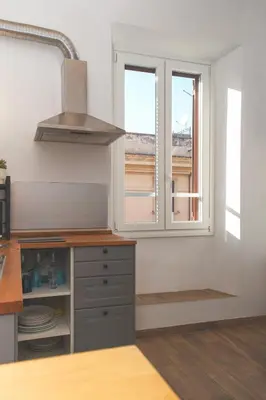 a kitchen with a window and a stove top oven at Elena's Apartment - Piramide Metro Station in Rome