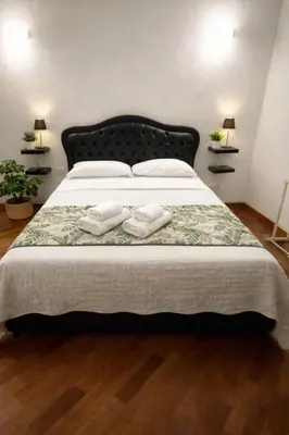 a bedroom with a large bed with two towels on it at Apartment Cerri 2 in Rome