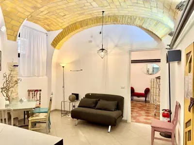 a living room with a couch and a table at Garbatella Vintage in Rome