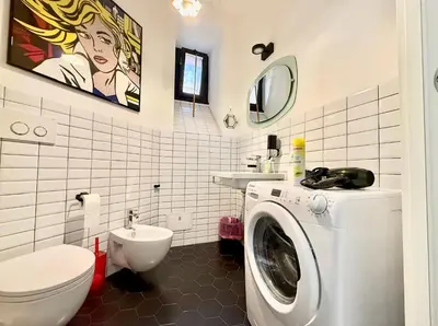 a bathroom with a washing machine and a toilet at Garbatella Vintage in Rome