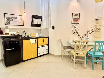 a kitchen with a black refrigerator and a table with chairs at Garbatella Vintage in Rome