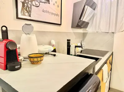 a kitchen with a counter top with a sink at Garbatella Vintage in Rome