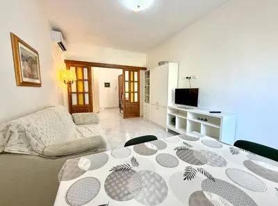 a living room with a table and a couch at 10 minuti da stazione Trastevere in Rome
