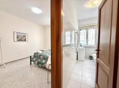 a bedroom with a bed and a bathroom at 10 minuti da stazione Trastevere in Rome