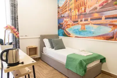 a room with a bed and a painting on the wall at Susy's Guest House - Room Spagna in Rome