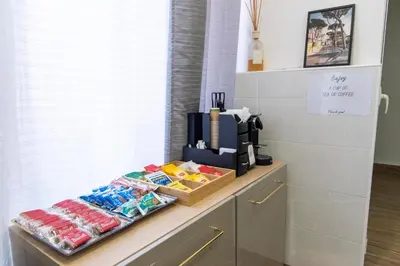 a counter with a coffee maker and snacks on it at Susy's Guest House - Room Spagna in Rome