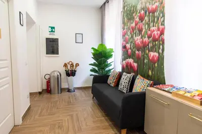 a living room with a couch and a painting of tulips at Susy's Guest House - Room Spagna in Rome