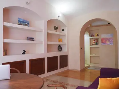a living room with a table and shelves at Giancarla Luxury Apartment Rome San Lorenzo - Termini in Rome