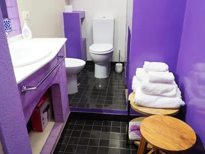 a purple bathroom with a sink and a toilet at Giancarla Luxury Apartment Rome San Lorenzo - Termini in Rome