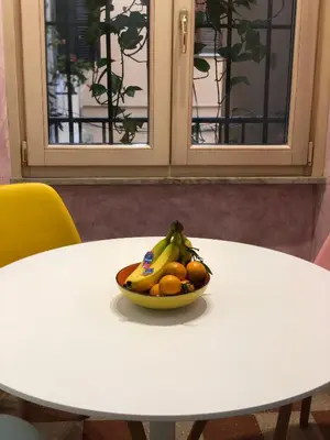 a bowl of fruit sitting on a white table at Giancarla Luxury Apartment Rome San Lorenzo - Termini in Rome
