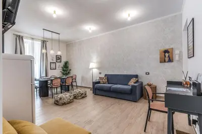 a bedroom with a bed and a blue chair at Napolehome Luxury Apartment in Rome