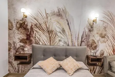 a bedroom with a bed and a wall with a mural at Napolehome Luxury Apartment in Rome