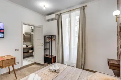 a bathroom with a sink and a mirror at Napolehome Luxury Apartment in Rome