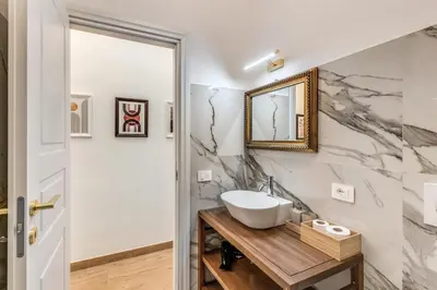 a bathroom with a sink and a mirror at Napolehome Luxury Apartment in Rome