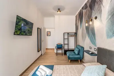 a living room with a couch and a chair at Napolehome Luxury Apartment in Rome