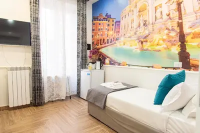 a bedroom with a bed and a painting on the wall at Susy's Guest House - Room Trevi in Rome