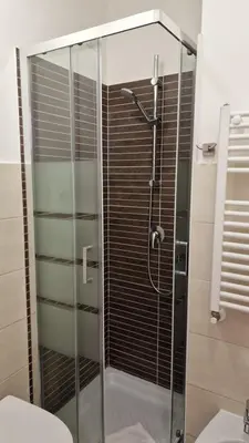 a glass shower in a bathroom with a toilet at Susy's Guest House - Room Trevi in Rome