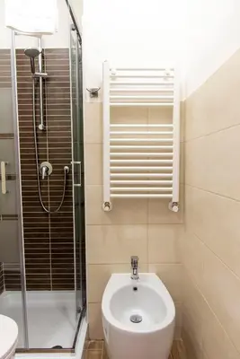 a bathroom with a shower and a toilet and a sink at Susy's Guest House - Room Trevi in Rome