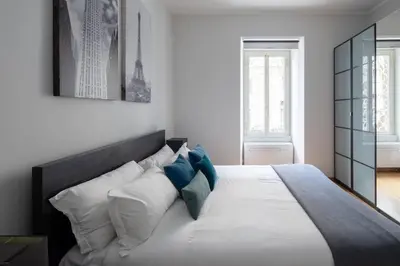 a bedroom with a large white bed with pillows at New apartment near Piazza del Popolo in Rome