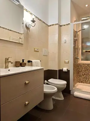 a bathroom with a toilet and a sink and a shower at Romeantique in Zama in Rome