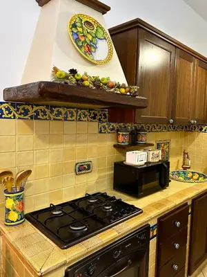 a kitchen with a stove and a plate on the wall at Romeantique in Zama in Rome