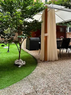 a garden with a tent and a tree in it at Romeantique in Zama in Rome