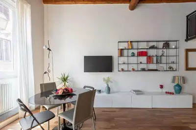 a dining room with a table and chairs at iFlat Modern & Relaxing apartment in Trastevere in Rome