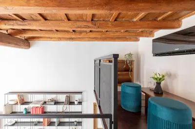 a room with wooden ceilings and blue stools at iFlat Modern & Relaxing apartment in Trastevere in Rome