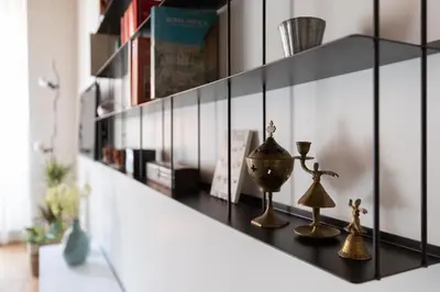 a shelf with various items on it in a room at iFlat Modern & Relaxing apartment in Trastevere in Rome