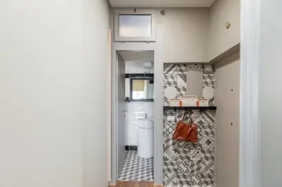 a hallway with a door leading to a bathroom with a toilet at iFlat Modern & Relaxing apartment in Trastevere in Rome