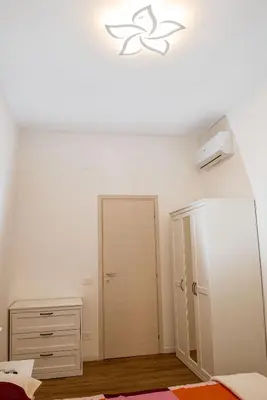 a bedroom with a bed and a closet and a dresser at Locazioni Ostiense - Joy House in Rome