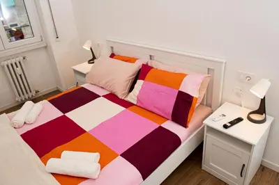 a small bedroom with a bed and a desk at Locazioni Ostiense - Joy House in Rome