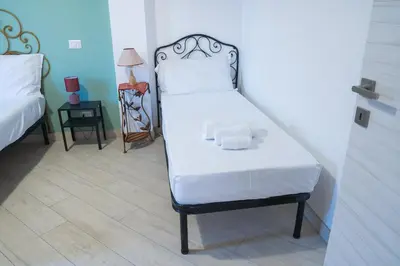 a bed in a room with a white mattress at San Paolo GreenHouse in Rome