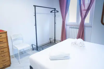 a bedroom with two beds and a dresser and a window at San Paolo GreenHouse in Rome