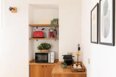 a kitchen with a microwave and a wooden cabinet at iFlat Quiet & cozy apt a few steps from Vatican in Rome