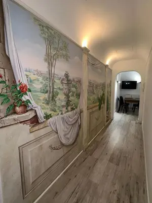 a hallway with a painting on the wall at Pietro's Central Apartament in Rome