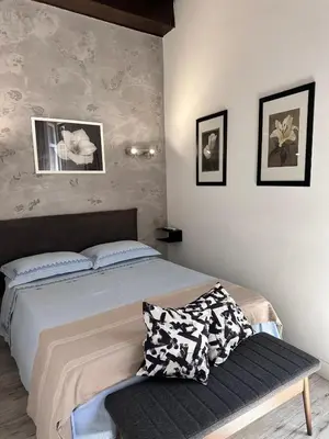 a bedroom with a bed and a bench in it at Pietro's Central Apartament in Rome