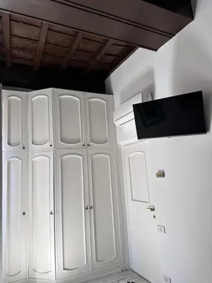 a white closet with a tv on top of it at Pietro's Central Apartament in Rome